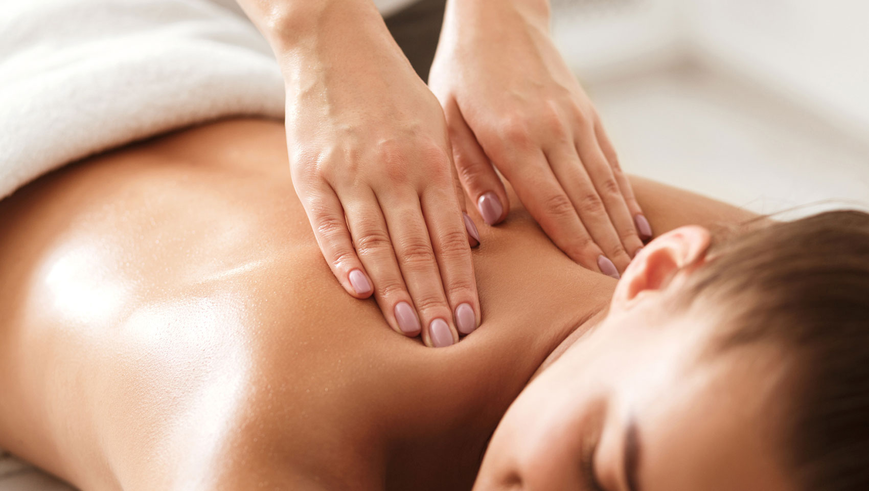 woman enjoying deep tissue massage in room