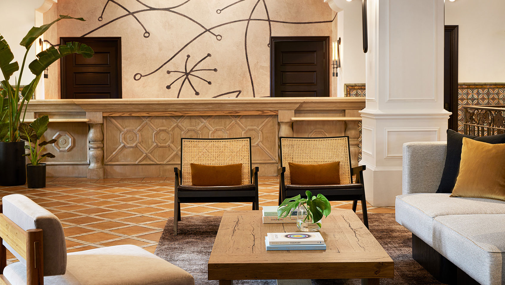 view of chairs, coffee table, front desk and couch in Canary lobby
